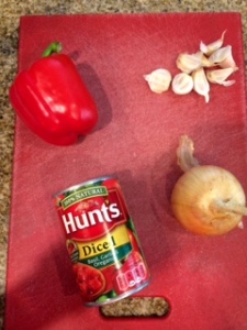 To make the sauce I diced a large yellow onion, half a bulb of garlic and a large red bell pepper. I sauteed them in oilve oil until cooked and added this can of Hunts tomatoes. I quickly pureed everything in a blender until the texture was desirable.